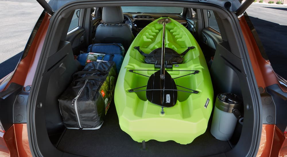 A green kayak is shown in the trunk of a red 2021 Chevy Trailblazer ACTIV.