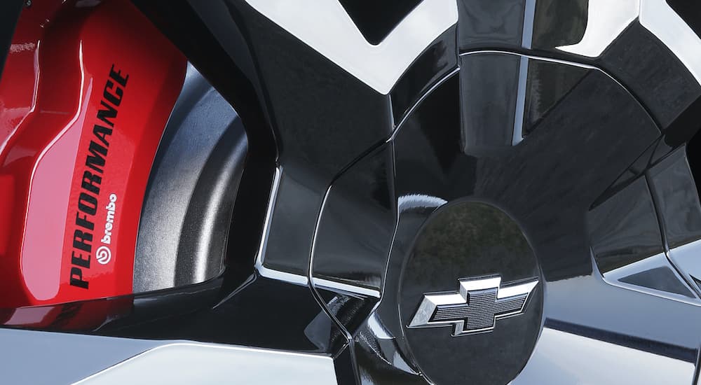 A close up shows the red Brembo caliper and alloy wheel on a 2020 Chevy Suburban RST.